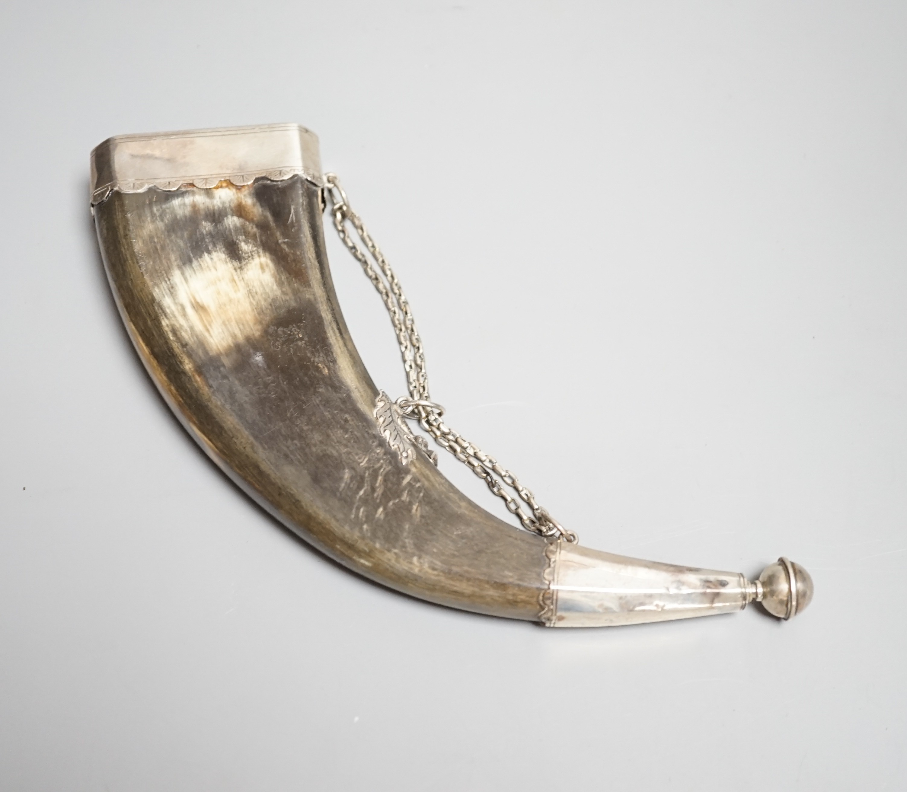 A Scottish silver mounted dress powder horn, early 19th century, engraved silver mounts (not hall marked) pierced end cap, dummy nozzle, central mount is chiseled as thistle. Length 25cms